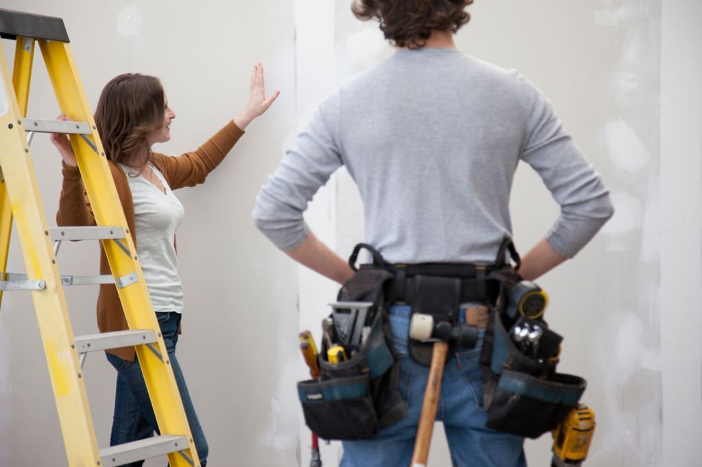 business owner instructing an independent contractor to paint walls
