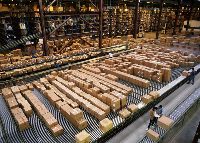 top view of a large industrial distribution warehouse with their working employee